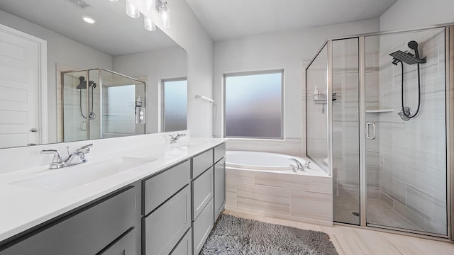 bathroom featuring vanity, tile patterned flooring, and separate shower and tub