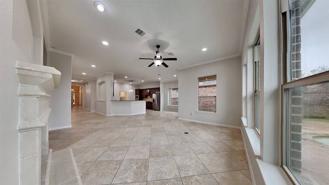 unfurnished living room with ceiling fan and ornamental molding