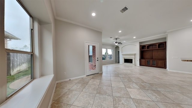 unfurnished living room with built in features, ceiling fan, crown molding, and light tile patterned flooring