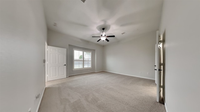 carpeted empty room featuring ceiling fan and vaulted ceiling