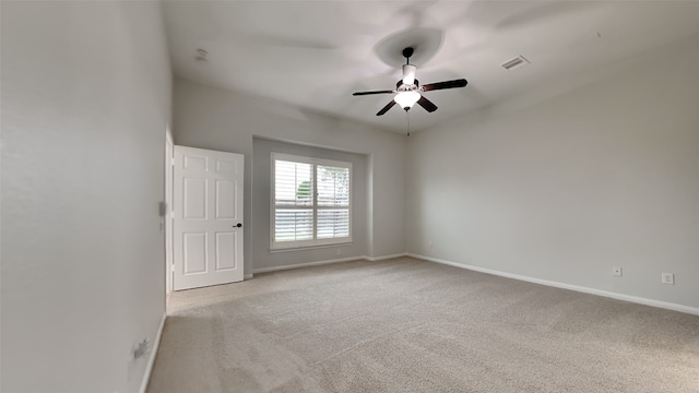 carpeted spare room with ceiling fan