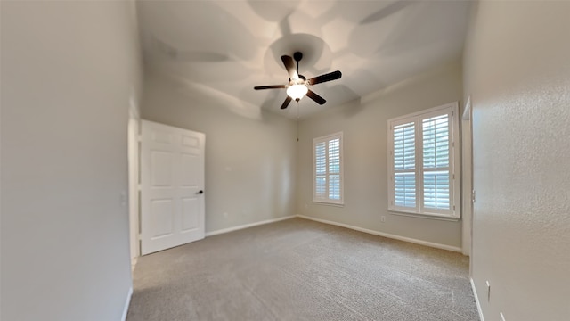 carpeted empty room featuring ceiling fan