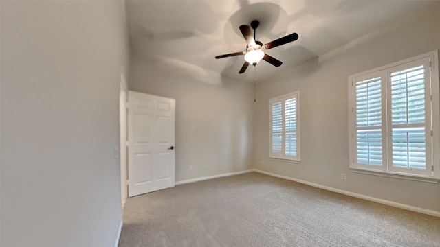 carpeted spare room with ceiling fan