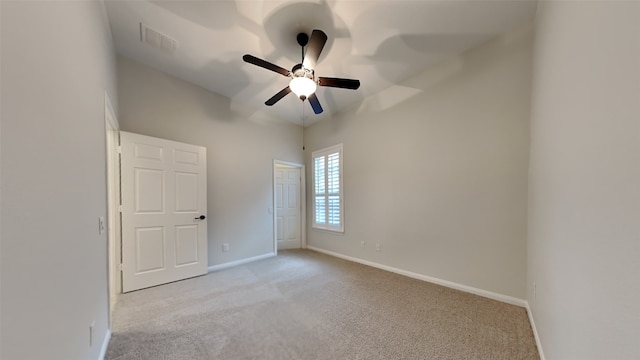 unfurnished room featuring light carpet and ceiling fan