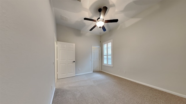 empty room with ceiling fan and light colored carpet