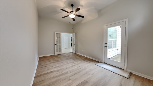 interior space featuring french doors, light wood-type flooring, and ceiling fan