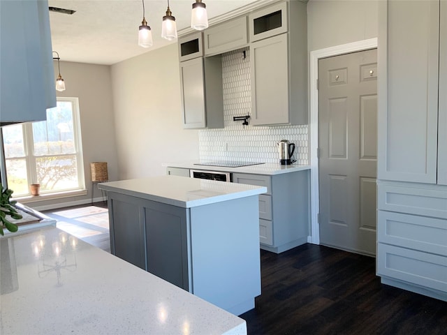 kitchen featuring tasteful backsplash, a center island, hanging light fixtures, and dark hardwood / wood-style floors