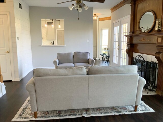 living room featuring ceiling fan, dark hardwood / wood-style flooring, and french doors