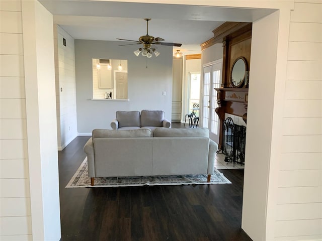 living room featuring hardwood / wood-style flooring and ceiling fan