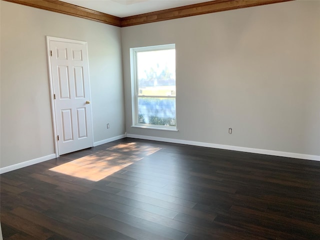 unfurnished room featuring ornamental molding and dark wood-type flooring