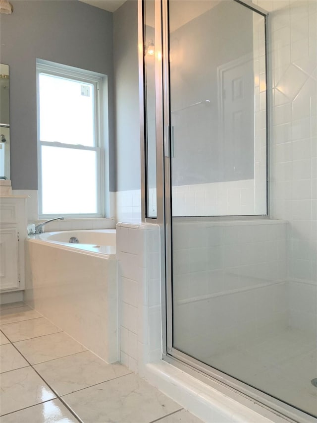 bathroom with vanity and separate shower and tub