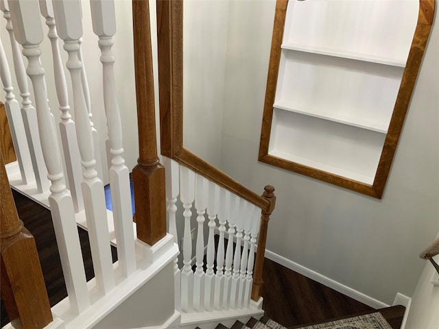 staircase with hardwood / wood-style floors