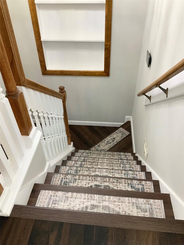 staircase with hardwood / wood-style floors