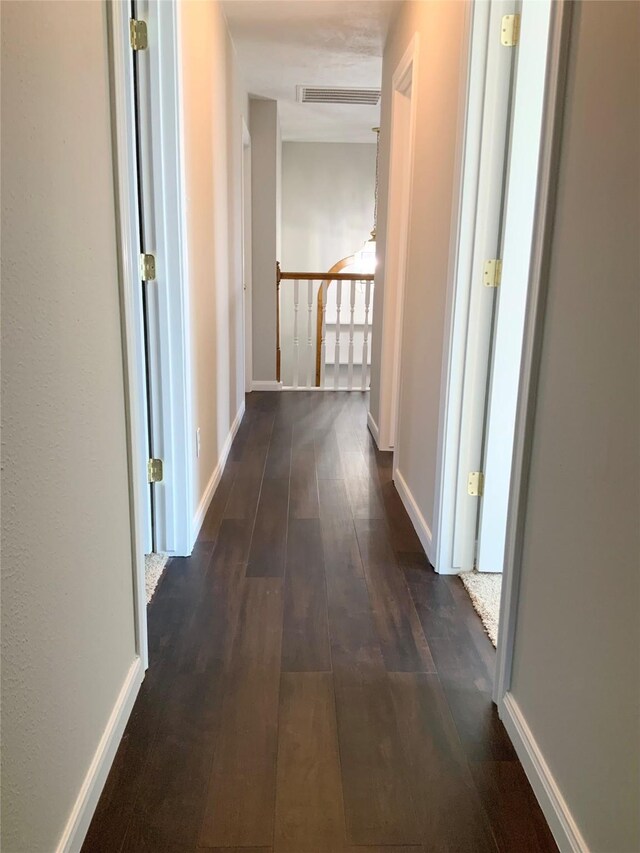 hallway featuring dark hardwood / wood-style flooring