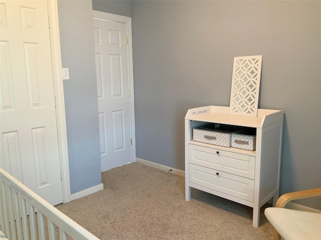 carpeted bedroom featuring a crib