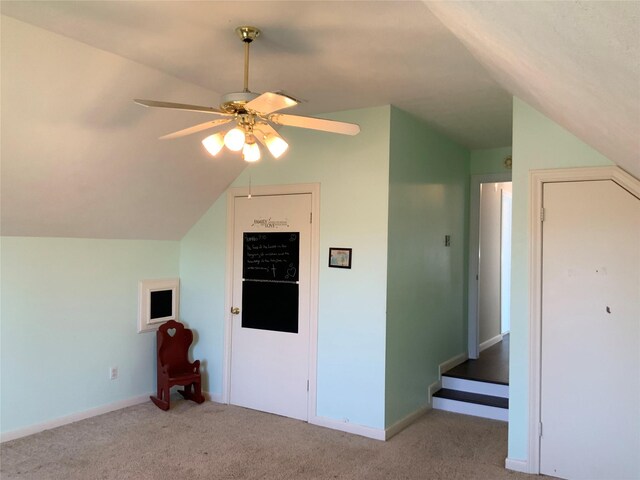 bonus room featuring ceiling fan, light colored carpet, and vaulted ceiling