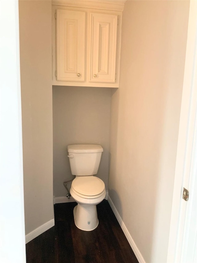 bathroom with hardwood / wood-style floors and toilet