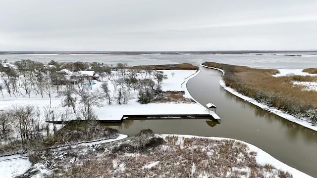 snowy aerial view with a water view