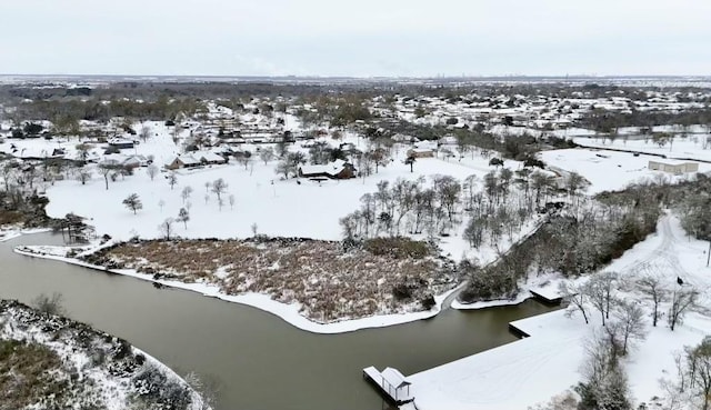 snowy aerial view with a water view