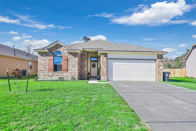 view of front of property featuring a front yard, a garage, and central AC unit