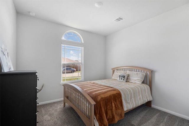 bedroom featuring dark colored carpet