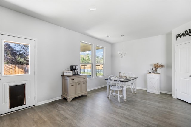 dining space featuring a notable chandelier and wood-type flooring