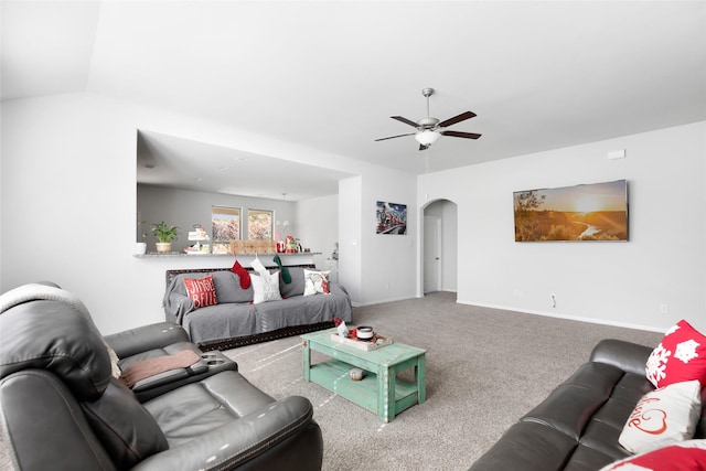 living room featuring ceiling fan, carpet, and vaulted ceiling