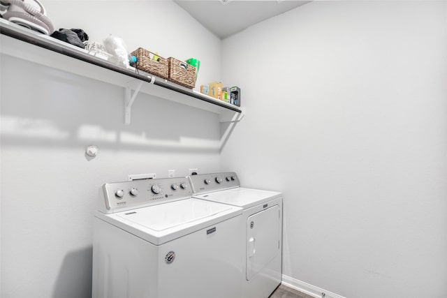 laundry area with washer and dryer and hardwood / wood-style floors