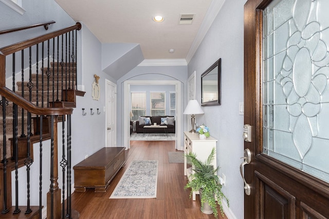 foyer featuring crown molding and dark hardwood / wood-style flooring