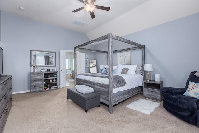 bedroom featuring connected bathroom, light colored carpet, ceiling fan, and lofted ceiling