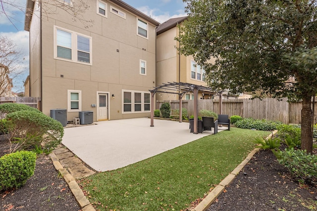 back of property with a patio, central AC, and a pergola