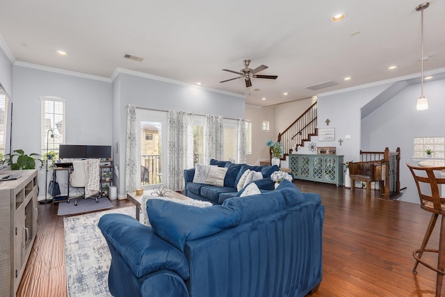 living room with a healthy amount of sunlight, dark hardwood / wood-style floors, and ornamental molding