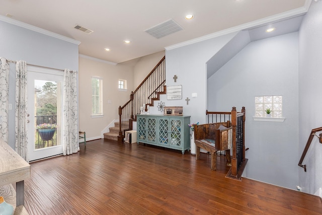 entrance foyer with dark hardwood / wood-style flooring and crown molding