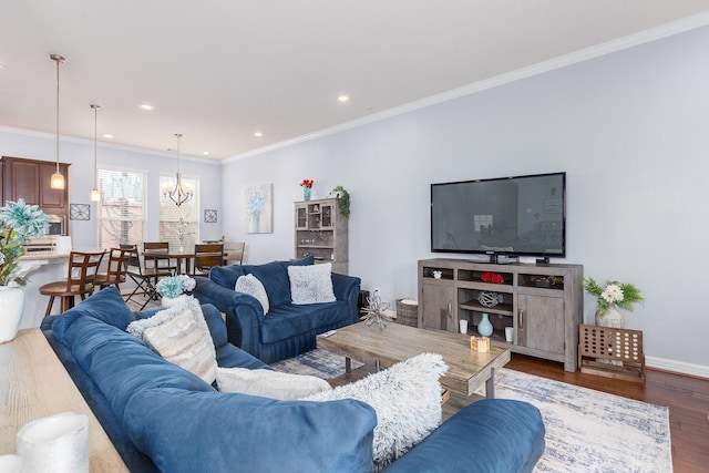 living room featuring hardwood / wood-style floors, a notable chandelier, and ornamental molding