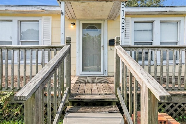 entrance to property with a wooden deck