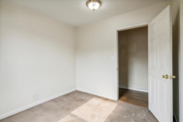 carpeted empty room with a textured ceiling