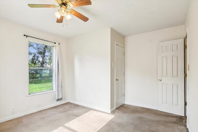 empty room featuring light carpet and ceiling fan