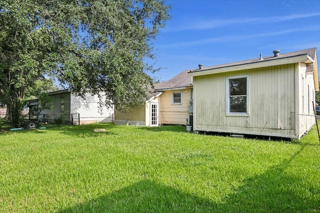 back of house with a lawn