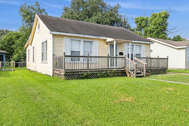 view of front of home featuring a wooden deck and a front lawn