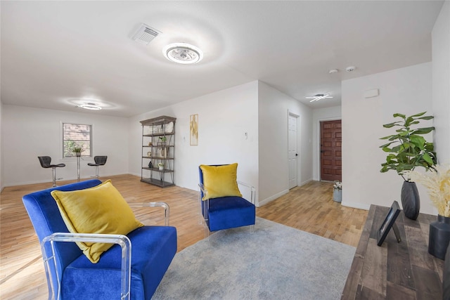 sitting room with wood-type flooring