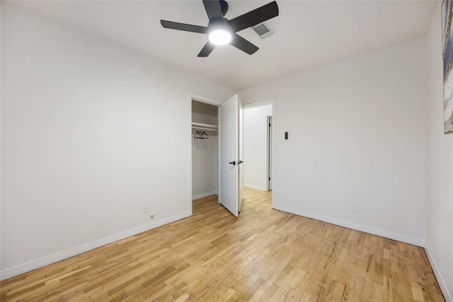 unfurnished bedroom with a closet, light hardwood / wood-style floors, and ceiling fan