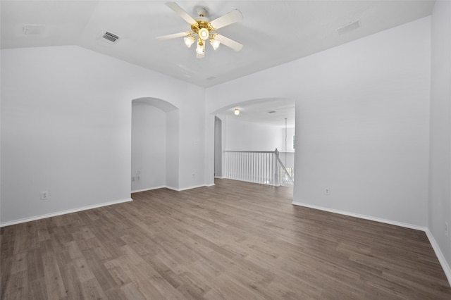 spare room with hardwood / wood-style floors, ceiling fan, and lofted ceiling