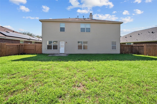 back of property featuring a lawn