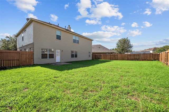 rear view of house with a yard