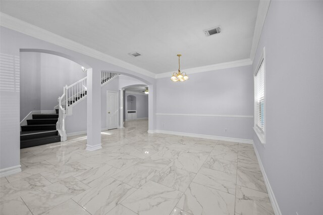 spare room featuring ornamental molding and a chandelier