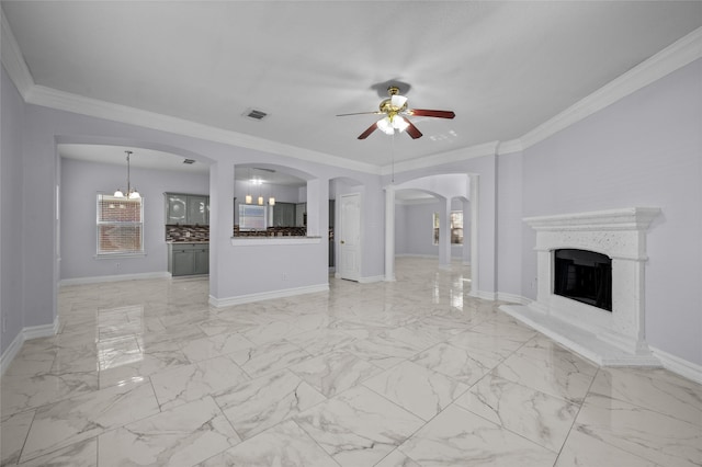 unfurnished living room with ceiling fan and crown molding