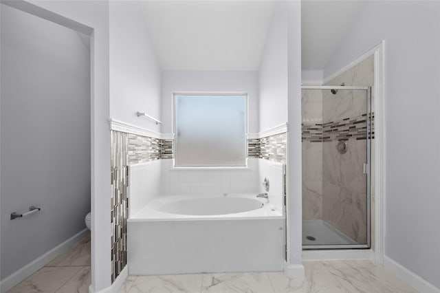 bathroom featuring separate shower and tub, lofted ceiling, and toilet