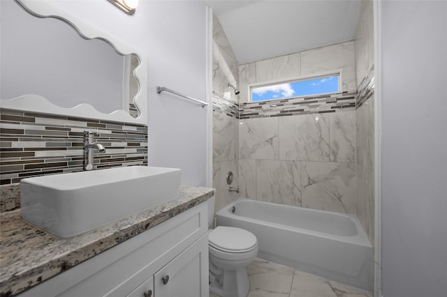 full bathroom featuring toilet, vanity, and tiled shower / bath combo