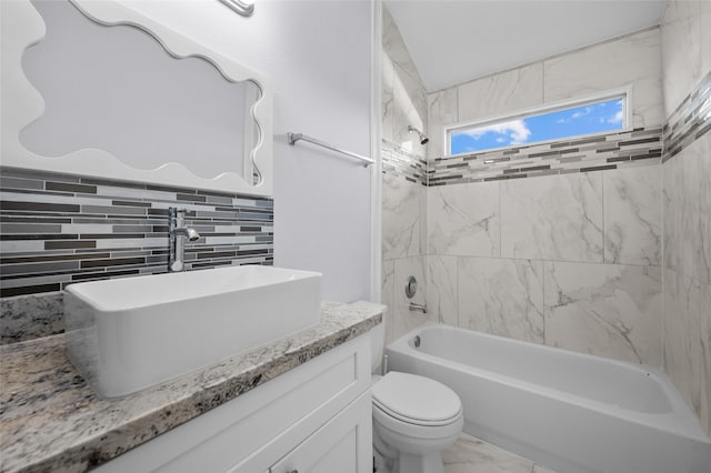 full bathroom featuring vanity, toilet, decorative backsplash, and tiled shower / bath