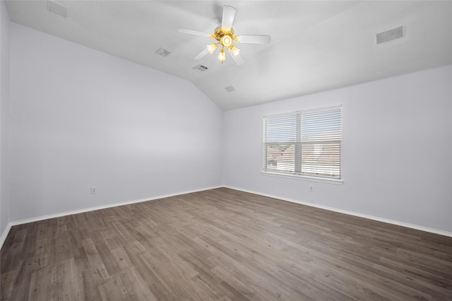 empty room featuring dark hardwood / wood-style flooring, ceiling fan, and lofted ceiling